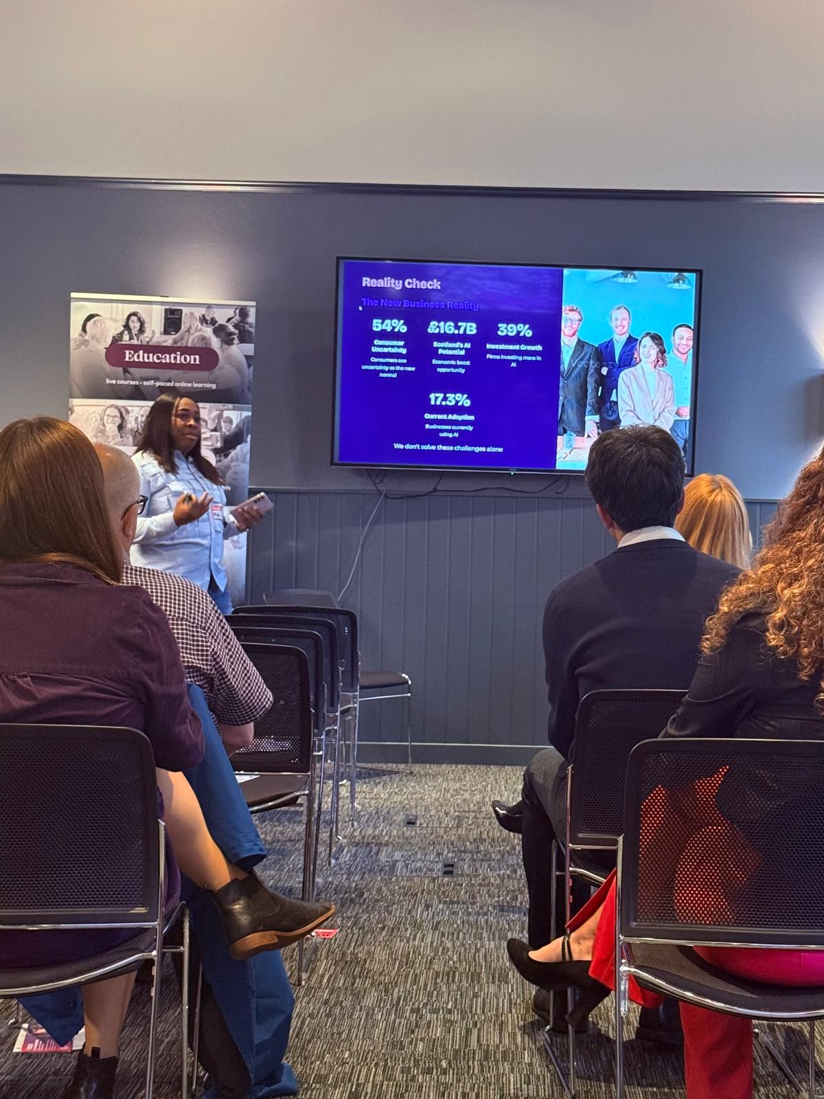 Abi Odedeyi presenting AI business statistics to an engaged audience